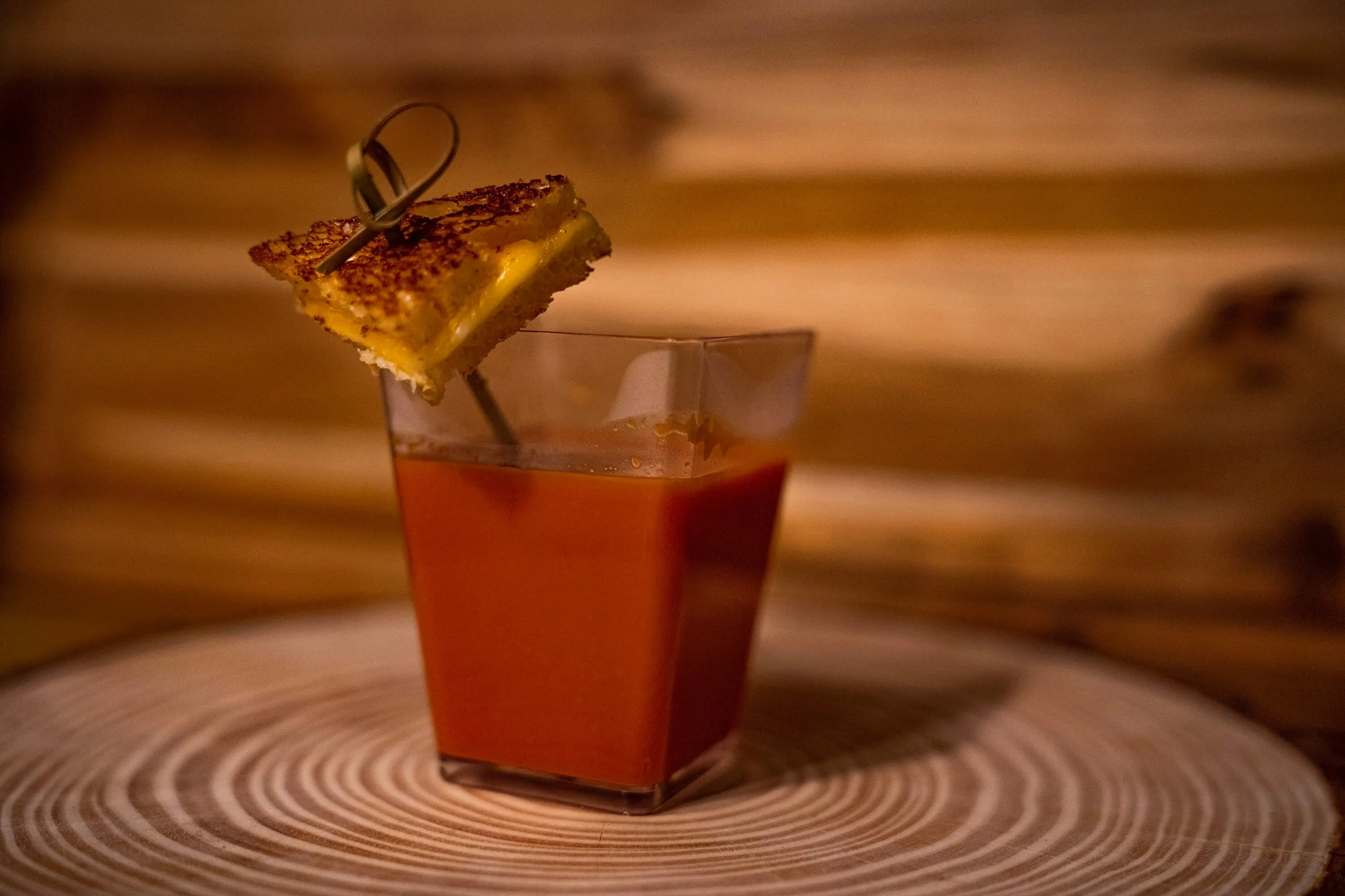 Tomato soup shot garnished with a mini grilled cheese