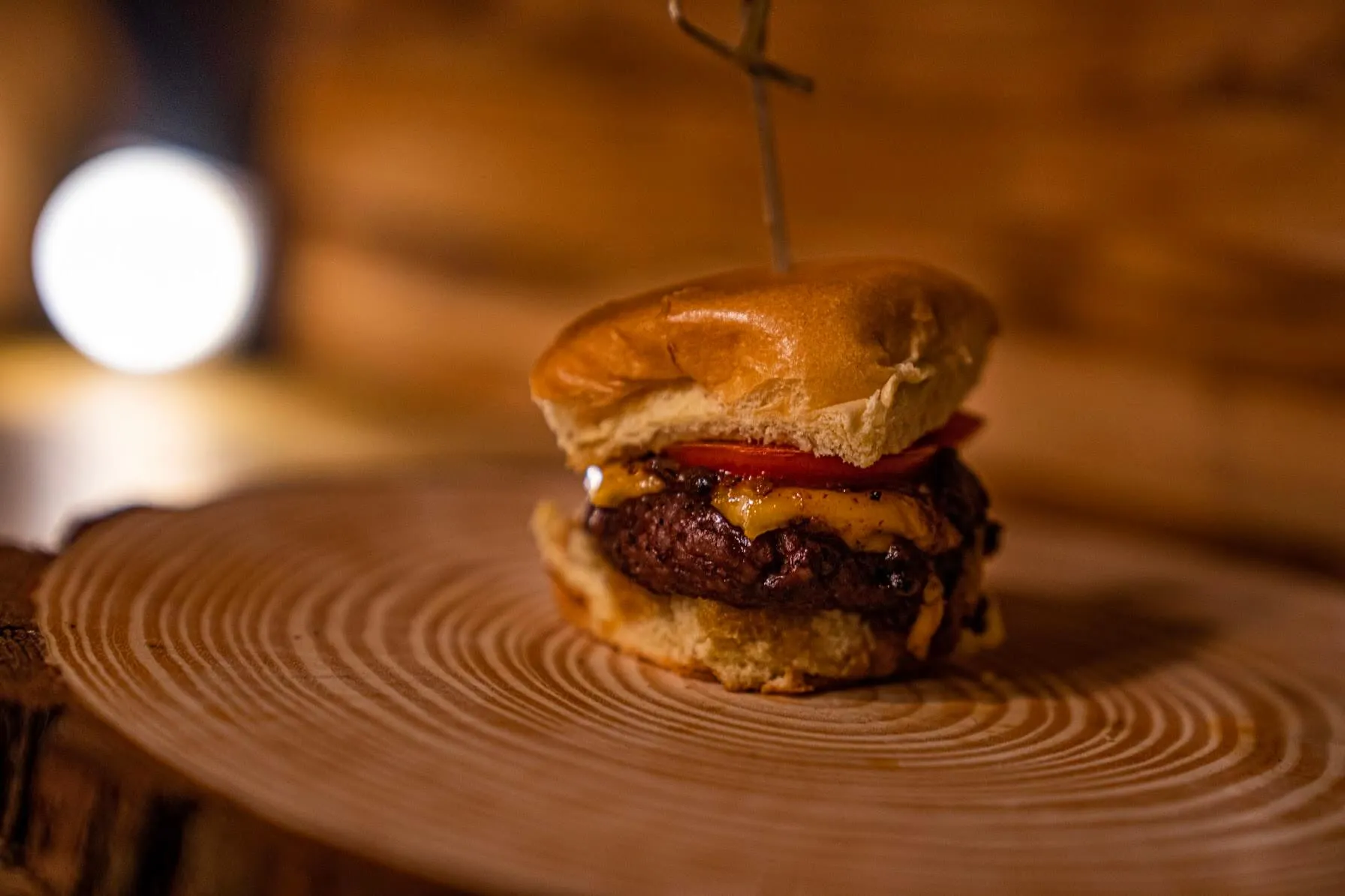 Mini cheeseburger slider with tomato on a toasted bun