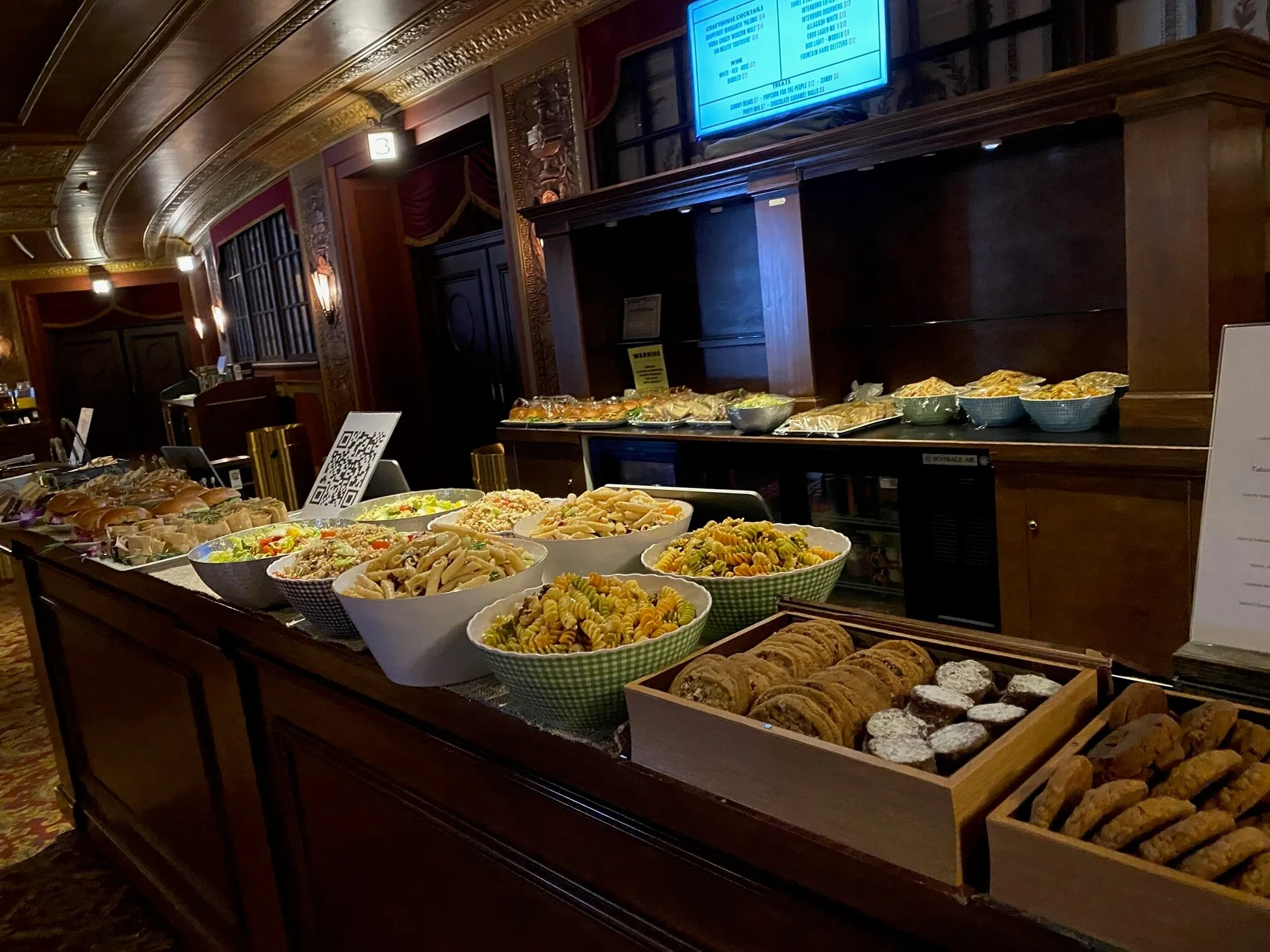 Theater-lobby buffet of pasta salads, sandwiches, and cookies