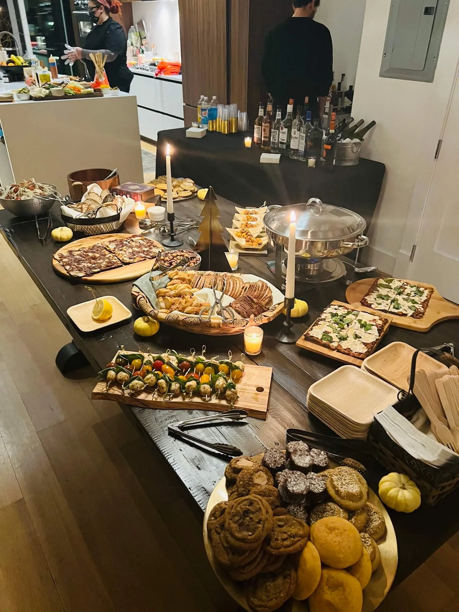Grazing buffet with flatbreads, caprese skewers, breads, and cookies
