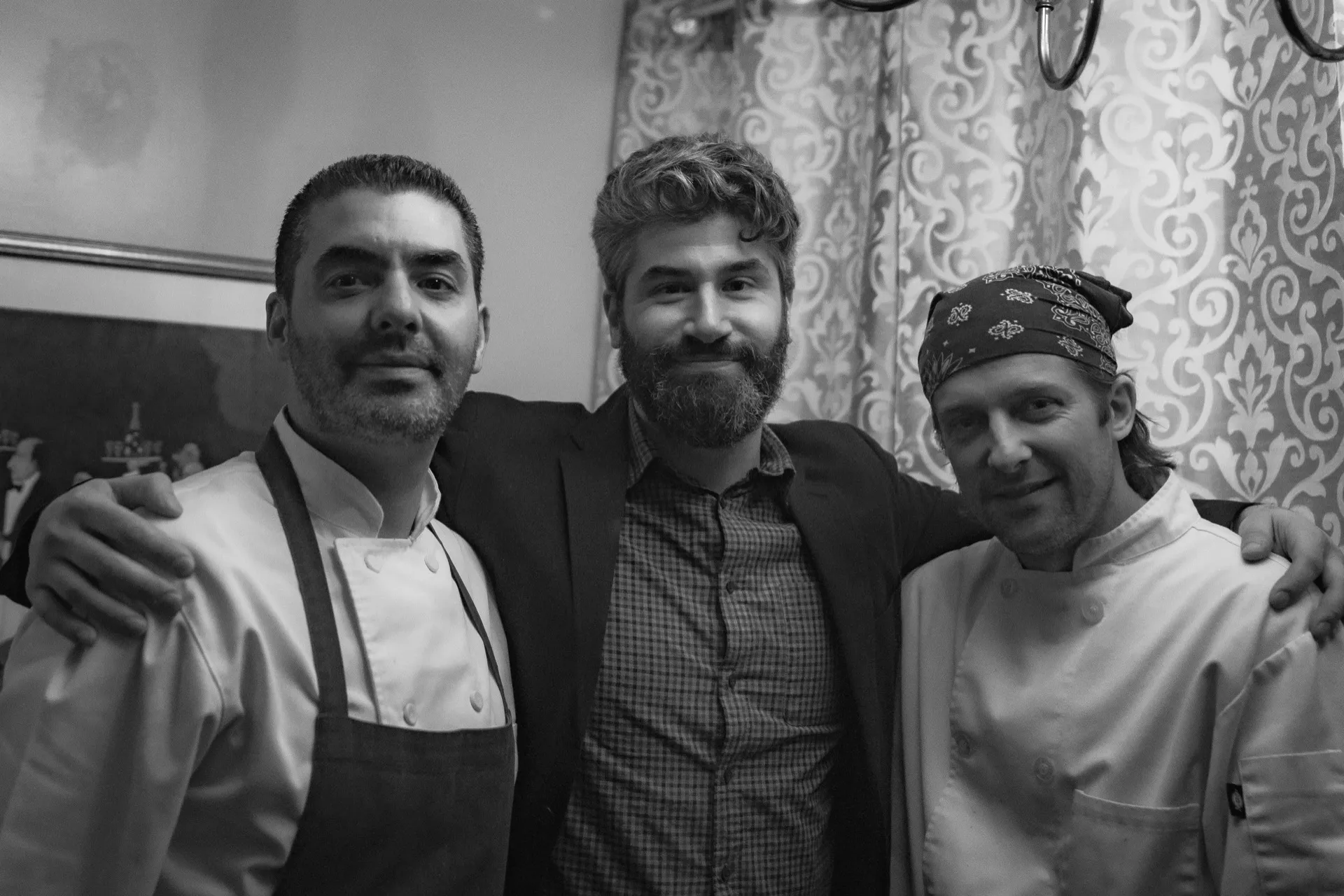 Black-and-white portrait of three smiling Just a Nibble team members